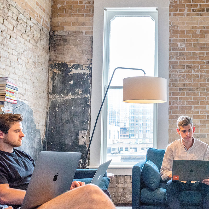 Two professionals working in the office of Spectrio in the USA