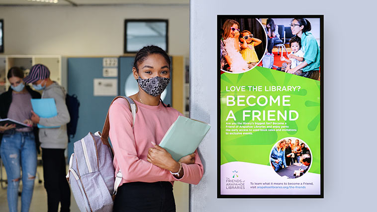Student in front of sign